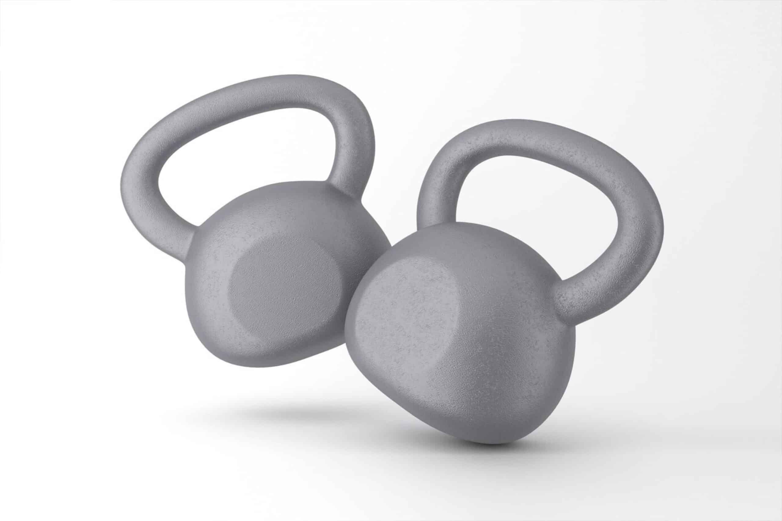 Two grey kettlebells on a white background, focused on fitness training equipment.