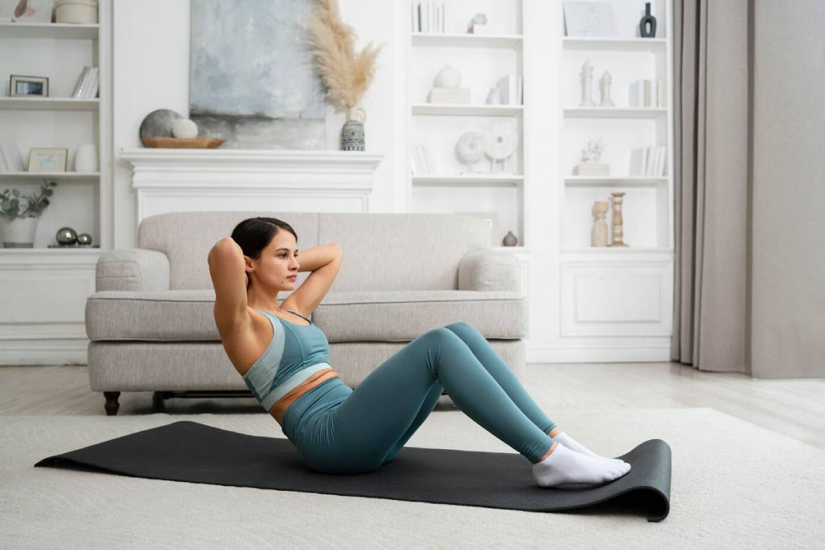Woman doing sit-ups on a mat in a stylish living room.